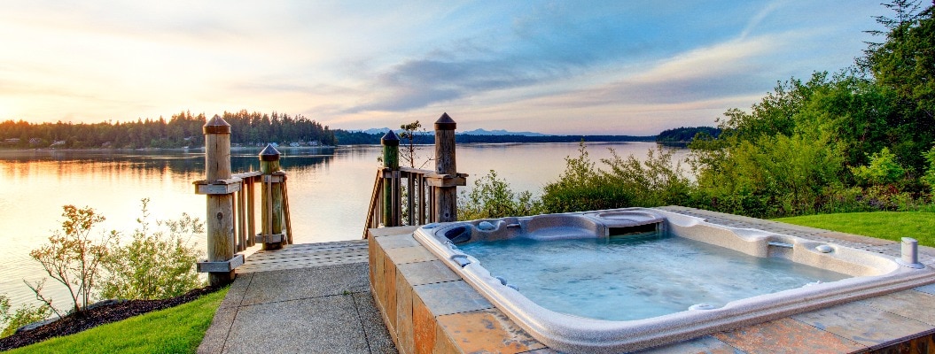 Awesome water view with hot tub at dusk in summer evening.