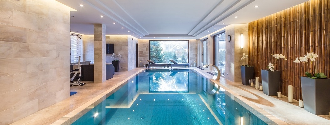 Magnificent indoor private pool with waterfall jet. Exercise equipment and sun beds.